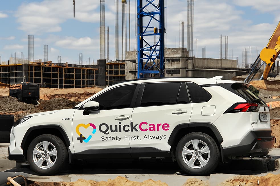 QuickCare vehicle on a construction site, ready for emergency response.